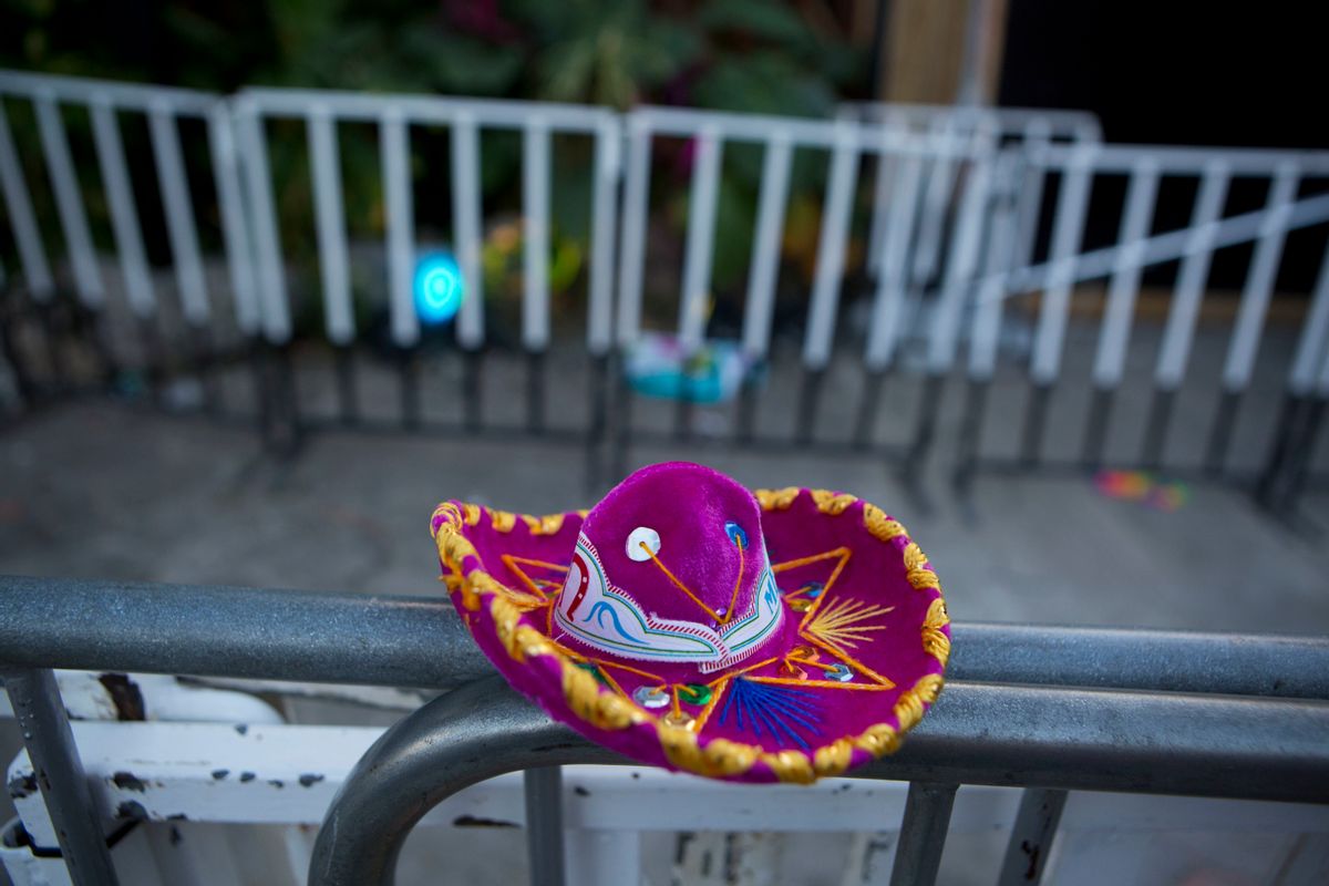 A Mexican tourist souvenir placed by a well-wisher sits on barriers blocking the entrance to the Blue Parrot club, where several people were killed in early morning gunfire, in Playa del Carmen, Mexico, Monday, Jan. 16, 2017. Deadly gunfire broke out in the crowded beachfront nightclub throbbing with electronic music before dawn on Monday, setting off a bloody stamped by screaming concertgoers at an international festival in this Caribbean resort.(AP Photo/Rebecca Blackwell) (AP)