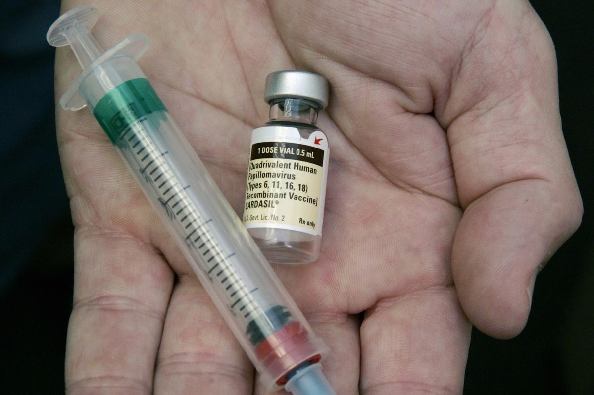 FILE - In this Aug. 28, 2006 file photo, a doctor holds a vial of the human papillomavirus (HPV) vaccine Gardasil in his Chicago office. A national estimate suggests that nearly half of U.S. men have mostly silent infections caused by the sexually-transmitted human papilloma virus, and that 1 in 4 has strains linked with several cancers. The study was released Thursday, Jan. 19, 2017. (AP Photo/Charles Rex Arbogast, File) (AP)