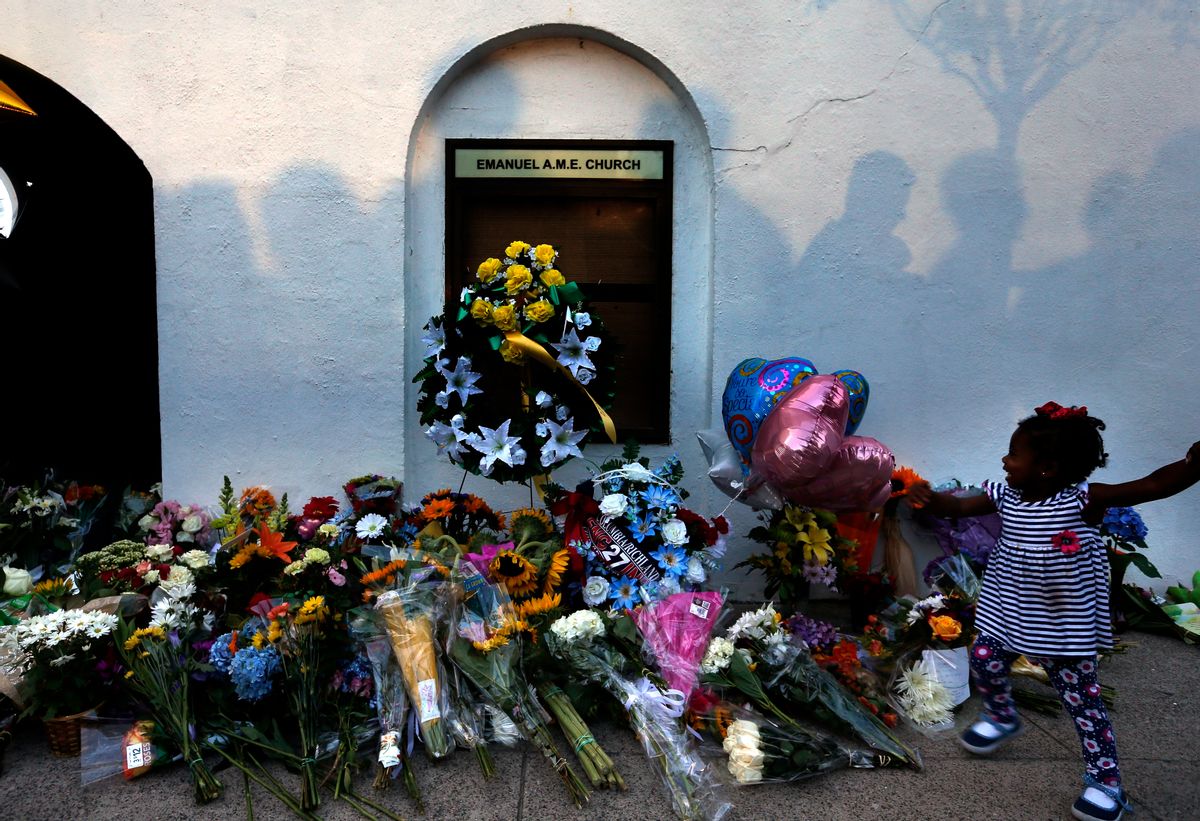 FILE-In this Thursday, June 18, 2015 file photo, mourners pass by a make-shift memorial on the sidewalk in front of the Emanuel AME Church following a shooting by Dylann Roof in Charleston, S.C. A federal jury will consider whether Roof should be sentenced to death or life in prison for killing nine black church members in a racially motivated attack. (AP Photo/Stephen B. Morton, File) (AP)