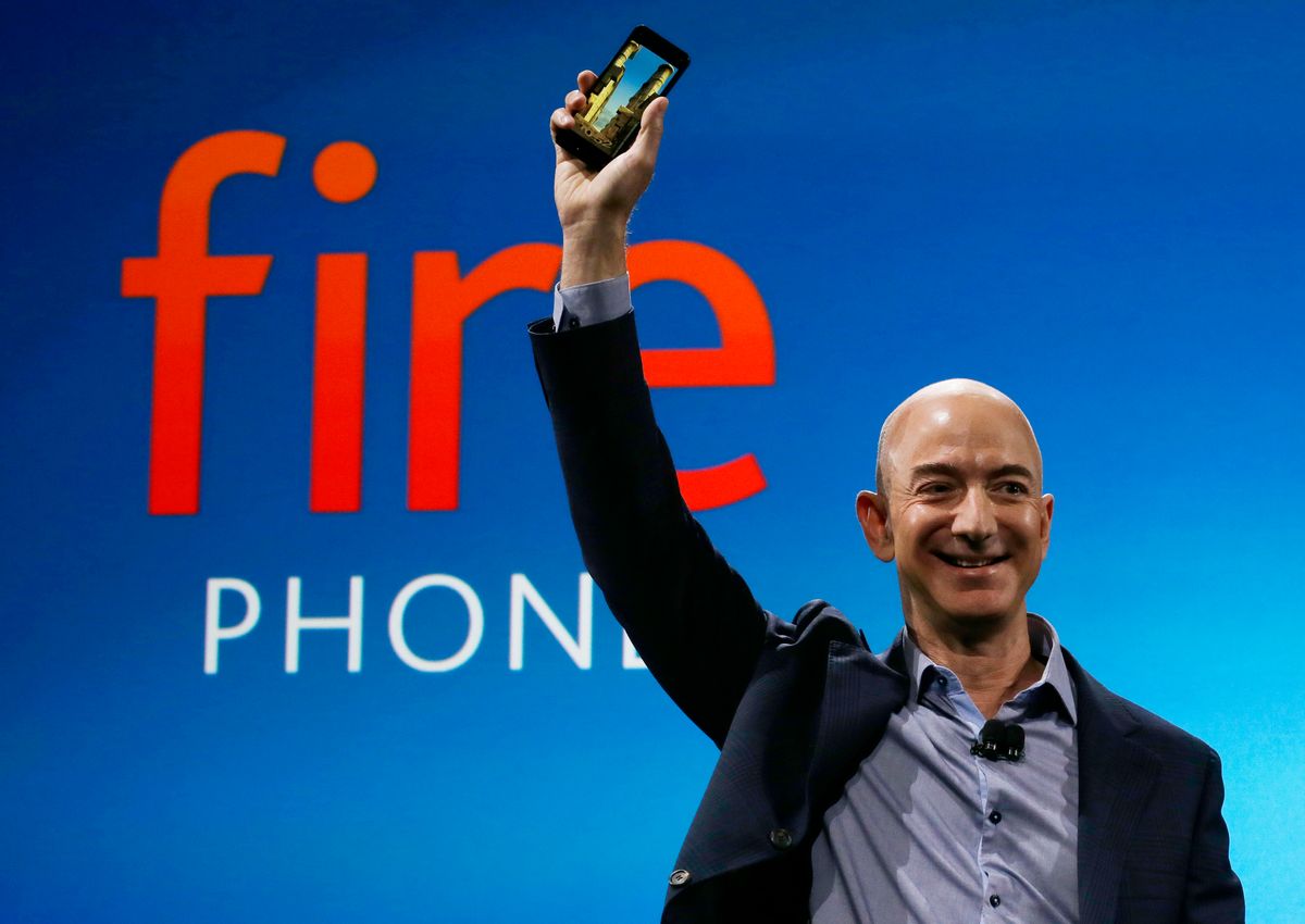 FILE - In this June 18, 2014 file photo, Amazon CEO Jeff Bezos introduces the new Amazon Fire Phone in Seattle. The eight individuals who own as much as half of the rest of the planet are all men, and have largely made their fortunes in technology. The founder and CEO of Amazon.com helped revolutionize the retail industry by popularizing online shopping. (AP Photo/Ted S. Warren, File) (AP)