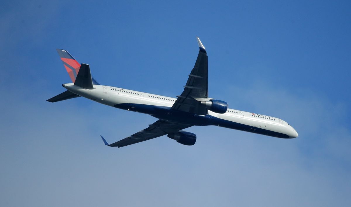 FILE - In this Sunday, March 6, 2016, file photo, a Delta Air Lines Boeing 757 flies overhead, in Seattle. On Thursday, Jan. 12, 2017, Delta Air Lines, Inc. reports financial results. (AP Photo/Ted S. Warren, File) (AP)