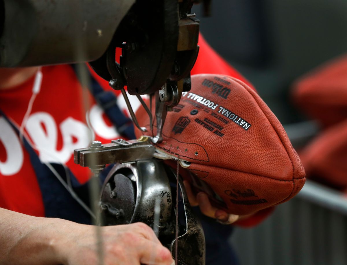 In this Monday, Jan. 23, 2017, photo an NFL Super Bowl LI football is sewn at the Wilson Sporting Goods factory in Ada, Ohio. Plant workers use turn-of-last-century sewing machines and other vintage equipment to make about 3,000 footballs per day, cutting, stitching and lacing each by hand. The 25-step process takes about three days to complete, but the pride in craftsmanship is evident in those who work there. (AP Photo/Charles Rex Arbogast) (AP)