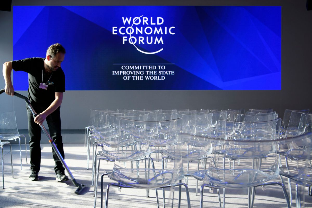 A worker vacuum-cleans the carpet inside the Congress Center ahead of the 47th annual meeting of the World Economic Forum, WEF, in Davos, Switzerland, Monday, Jan. 16, 2017. (Laurent Gillieron/Keystone via AP) (AP)