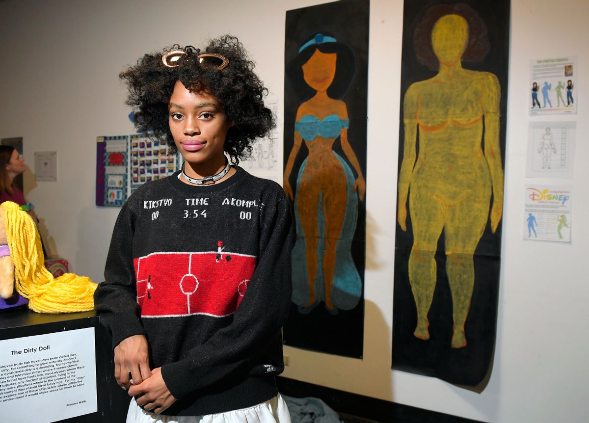 In this Friday, Dec. 9, 2016, photo, Ajani Russell poses with her artwork "Female Figures" prior to the Animated Women symposium at California Institute of the Arts, in Valencia, Calif. The California Institute of the Arts was created partly by Walt Disney's desire to bring more top-flight animators into the profession. And it has during its 47 years, though for a long time almost all were men. Now, nearly three-quarters of CalArts' more than 250 animation students are women, and there's a new goal: Ensure that when they land jobs, they get to draw female characters reflective of the real world and not just the nerds, sex bombs, tomboys or ugly villains who proliferate now. (AP Photo/Mark J. Terrill) (AP)