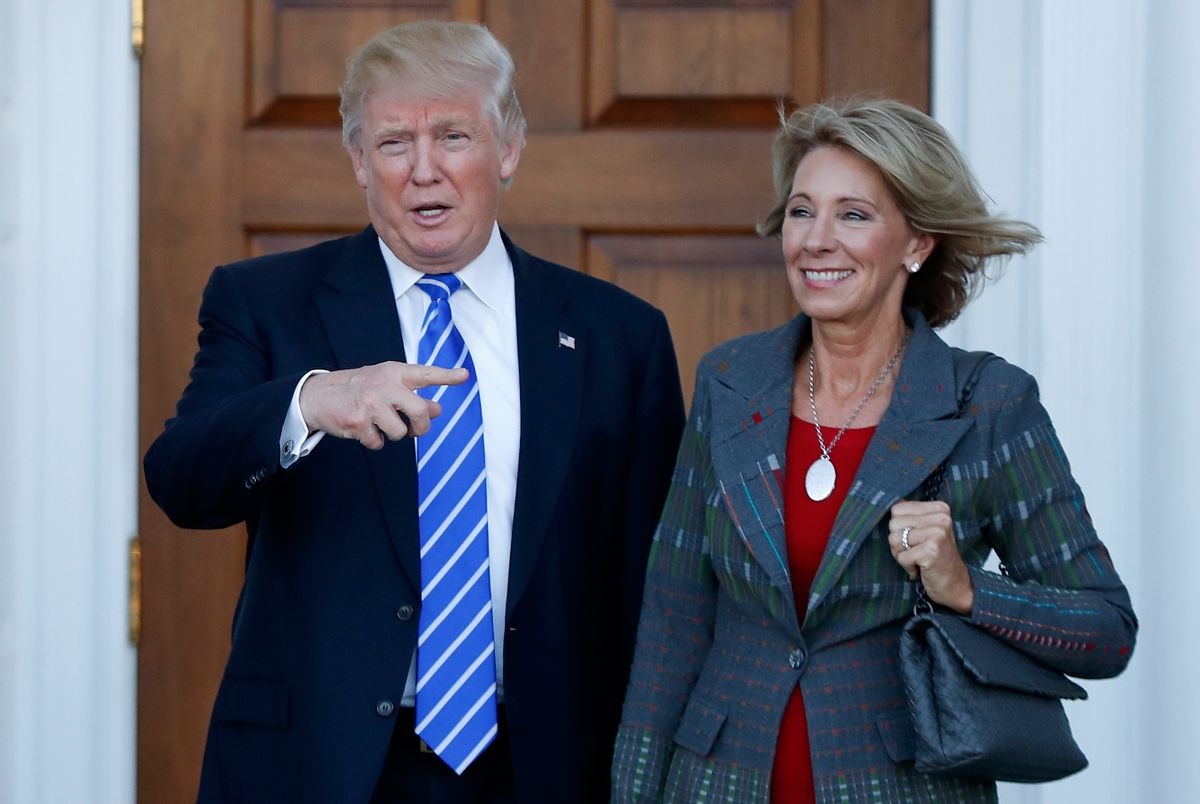 FILE - In this Nov. 19, 2016 file photo, President-elect Donald Trump stands with Education Secretary-designate Betsy DeVos in Bedminster, N.J.  DeVos has spent over two decades advocating for school choice programs, which give students and parents an alternative to traditional public school education. Her confirmation hearing was scheduled for Jan. 17. (AP Photo/Carolyn Kaster, File) (AP Photo/Carolyn Kaster)