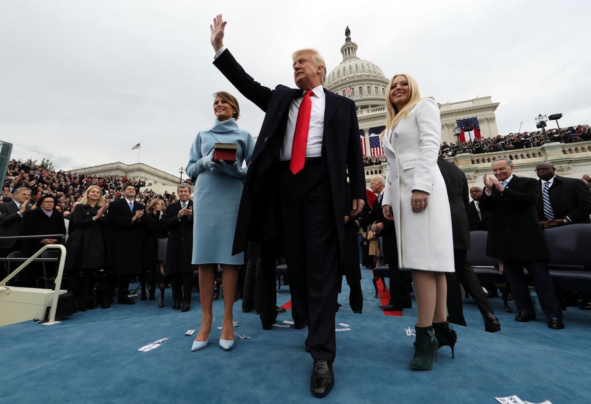 President Donald Trump waves after taking the oath of office as his wife Melania holds the Bible, and Tiffany Trump looks out to the crowd, Friday, Jan. 27, 2017 on Capitol Hill in Washington. (Jim Bourg/Pool Photo via AP) (AP)