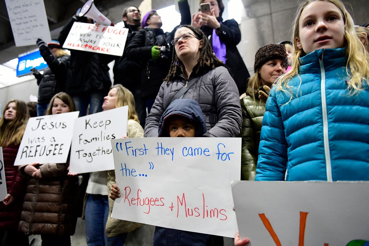 Stephanie Hartley-Bah and her son Jah'kier Hartley, 7, both of Bear, Del., listen during a protest of President Donald Trump's travel ban on refugees and citizens of seven Muslim-majority nations, Sunday, Jan. 29, 2017, at Philadelphia International Airport in Philadelphia. (AP Photo/Corey Perrine) (AP)