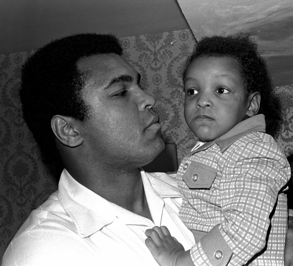 Heavyweight boxing champion Muhammad Ali, and Little Muhammad Ali, his 2 1/2 year old son, arrive at Miami Beach, Fla.   (Associated Press)