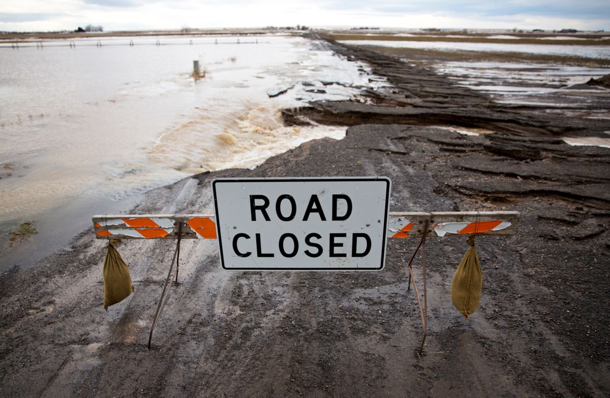 In this Thursday, Feb. 9, 2017 photo, a road destroyed by floodwater is closed in Buhl, Idaho. Warm weather is melting historic snowfall, particularly in the Magic Valley, where a canal was partially breached overnight Thursday, flooding an area near Castleford and Buhl.
(Pat Sutphin/The Times-News via AP)/The Times-News via AP) (AP)