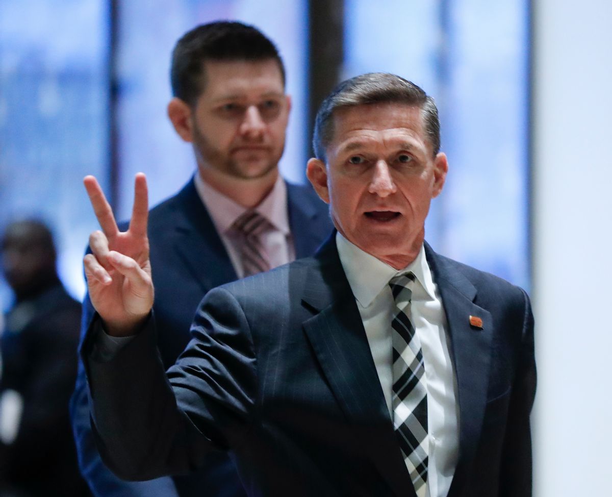FILE- In this Nov. 17, 2016, file photo, retired Lt. Gen Michael Flynn gestures as he arrives with his son Michael G. Flynn, left, at Trump Tower in New York. Flynn was fired by one American commander-in-chief for insubordination, Now he may removed by another. Flynn resigned as President Donald Trump's national security adviser Monday, Feb. 13, 2017. (AP Photo/Carolyn Kaster, File) (AP)