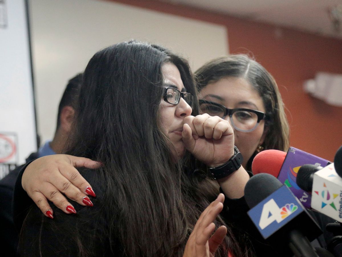 Marlene Mosqueda, left, who's father was deported early Friday, Feb. 10, 2017, is comforted at a news conference by her attorney Karla Navarrette at The Coalition for Humane Immigrant Rights of Los Angeles (CHIRLA). Navarrete, said she sought to stop Mosqueda from being placed on a bus to Mexico and was told by ICE that things had changed. She said another lawyer filed federal court papers to halt his removal. (AP Photo/Nick Ut) (AP)