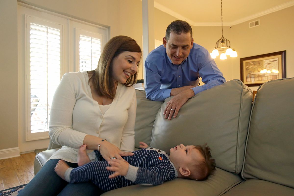 In this Tuesday, Feb. 7, 2017 photo, Lauren Nieves-Taranto, left, and husband Francisco play with their youngest child Nicolas, 4-months, at their home in Windermere, Fla. Nieves-Taranto covered the entire $8,000 bill from the birth of Nicolas last year with his account balance from a health savings account, or HSA. () (AP Photo/John Raoux)
