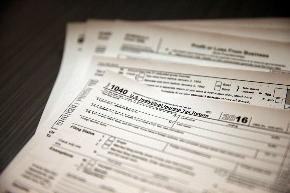 In this Jan. 14, 2017, photo, tax forms sit on a desk at the start of the tax season rush, inside the offices of tax preparation firm Infinite Tax Solutions, in Boulder, Colo. Filing taxes early could speed your return and protect your identity. (AP Photo/Brennan Linsley) (AP)
