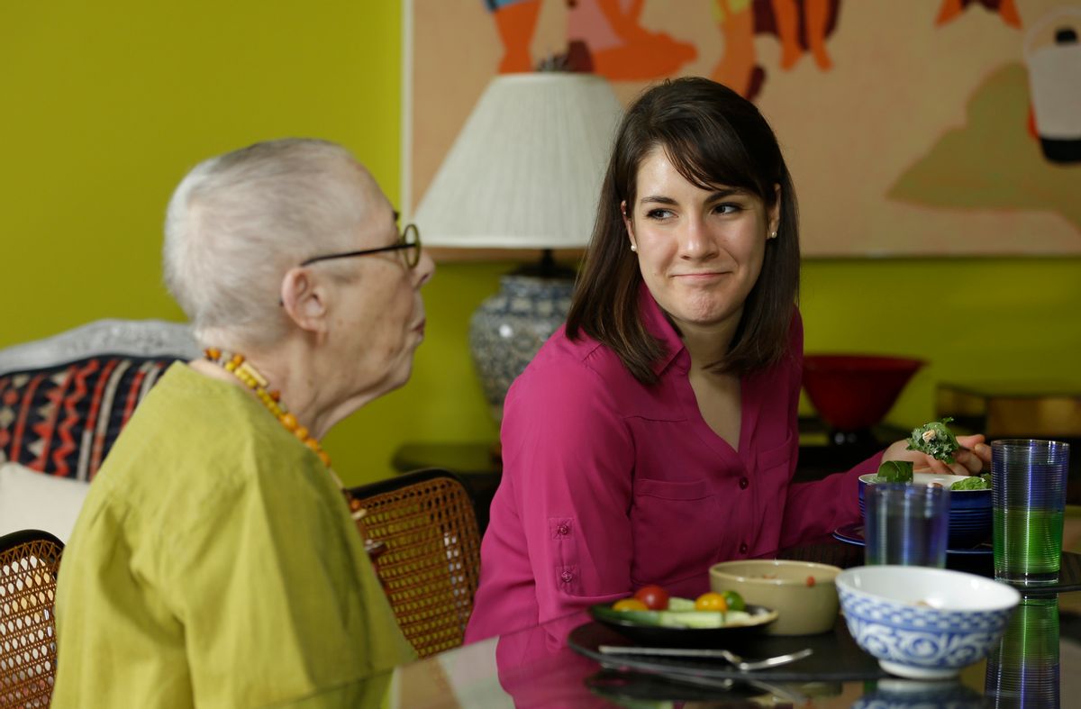 In this Friday, Feb. 17, 2017 photo, Laura Berick, left, a retired art dealer, has lunch with Justine Myers at Berick's home at Judson Manor, in Cleveland. In a research project, graduate-level students live among residents of the Judson Manor retirement home. The study looks at the impact of isolation and loneliness, aging and stereotypes of retirees by students and vice versa. Myers is an artist-in-residence at Judson Park. She is an Oberlin College graduate student studying music. (AP Photo/Tony Dejak) (AP)