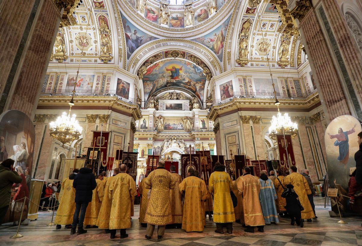 Orthodox priest and believers attend a Sunday service in the St. Isaac's Cathedral in St.Petersburg, Russia, Sunday, Feb. 12, 2017. St. Petersburg Orthodox eparchy held a cross procession around the city's St. Isaac's Cathedral to support the plans on the cathedral's handover to the Russian Orthodox Church. Currently the Cathedral has a museum status. The cross procession gathered around 1000 people. (AP Photo/Dmitri Lovetsky) (AP)
