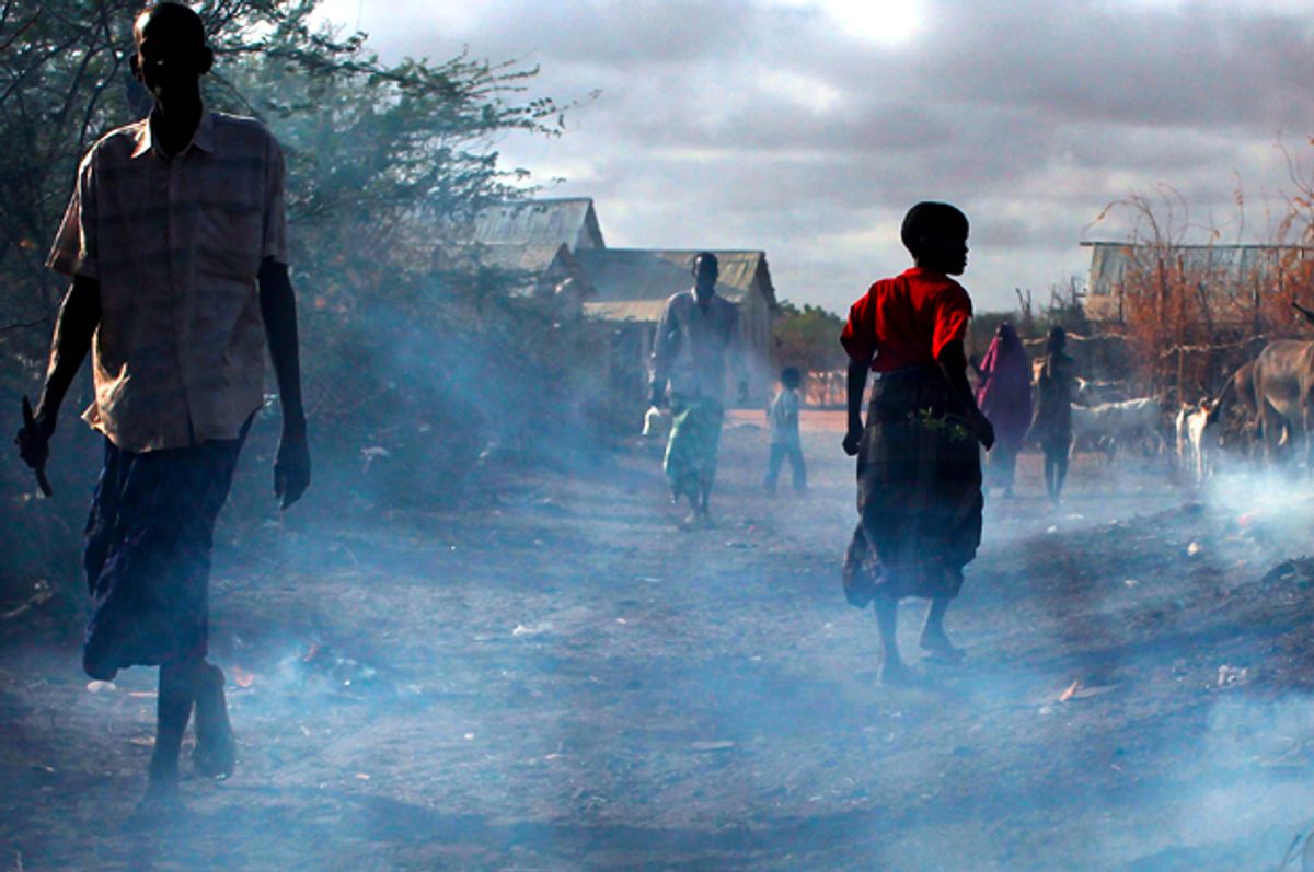 People walk through burning refuse in Dadaab, Kenya the world's biggest refugee complex August 20, 2009 in Dadaab, Kenya   (Getty/Spencer Platt)