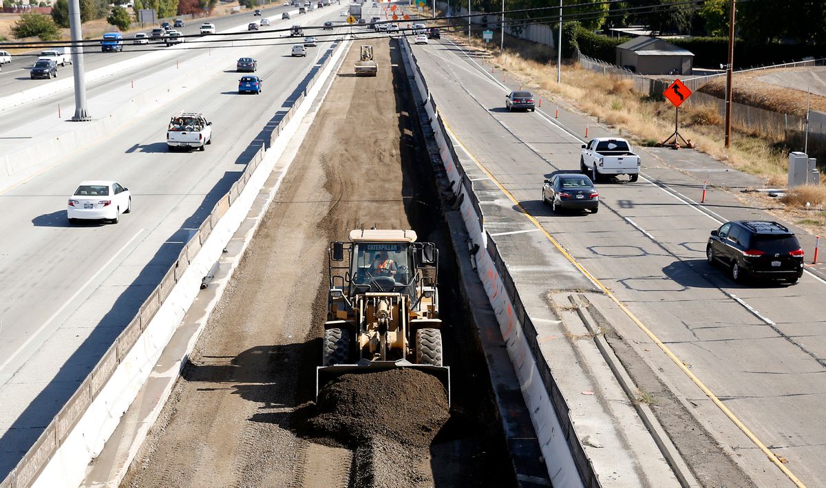 FILE - In this Oct. 15, 2015, file photo, vehicles pass a highway construction site on Interstate 80 in Sacramento, Calif. A plan to revitalize America’s aging infrastructure put forward by two President Donald Trump administration economic advisers relies on a transportation financing scheme that hasn’t been tried before and comes with significant risks. (AP Photo/Rich Pedroncelli, File) (AP)