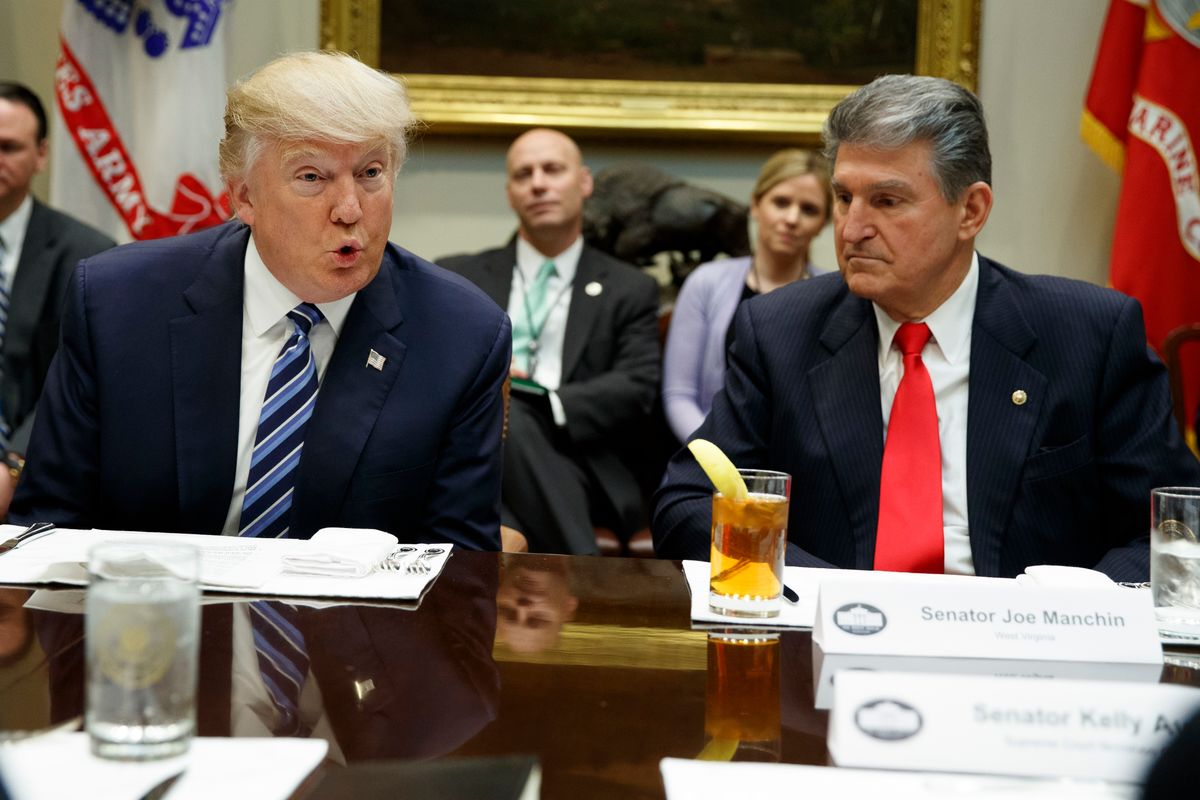 Sen. Joe Manchin, D-W.Va., listens at right as President Donald Trump speaks during a meeting with Senators on his Supreme Court Justice nominee Neil Gorsuch, Thursday, Feb. 9, 2017, in the Roosevelt Room of the White House in Washington. (AP Photo/Evan Vucci) (AP)