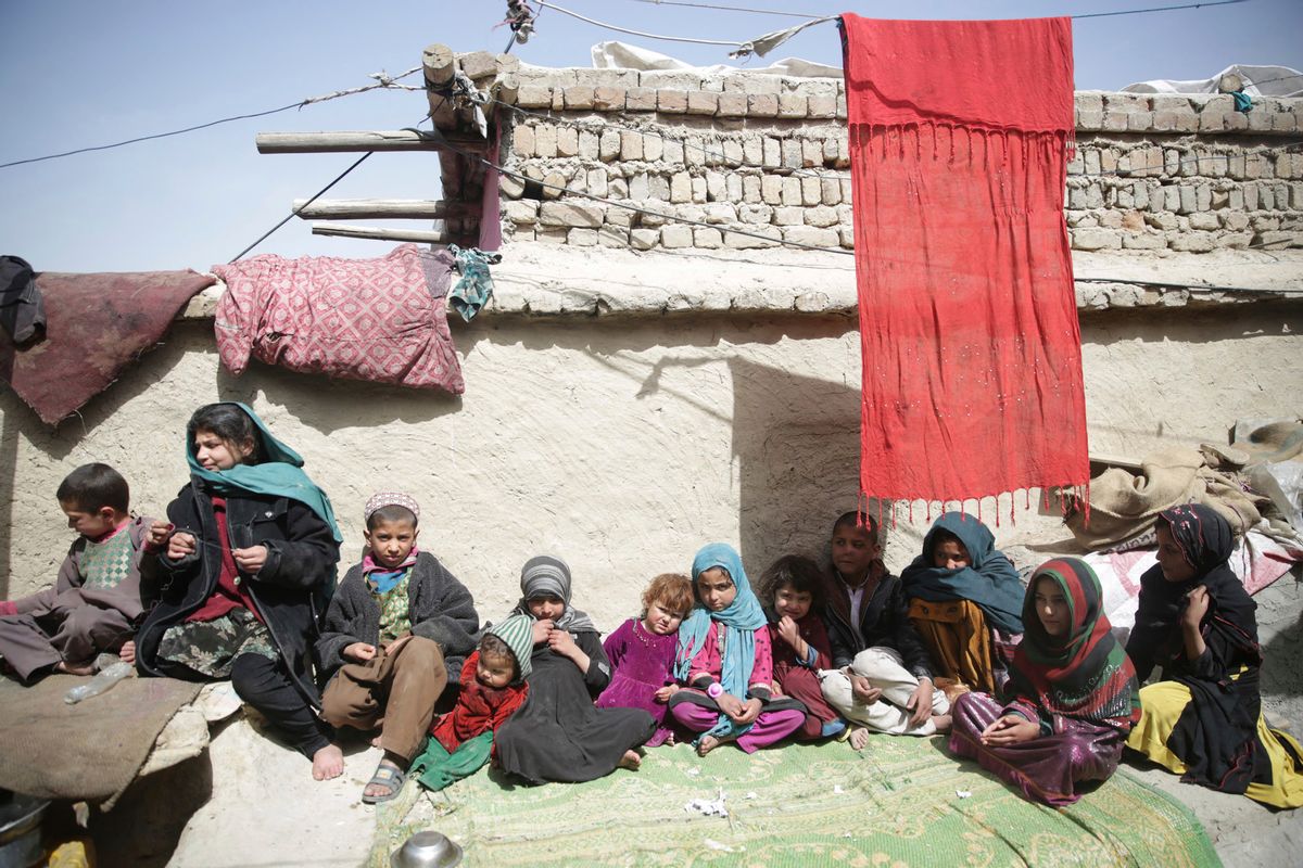 In this Sunday, March 19, 2017 photo, Children sit in the sun in their home in Kabul, Afghanistan. An aid group says nearly a third of all children in war-torn Afghanistan are unable to attend school, leaving them at increased risk of child labor, recruitment by armed groups, early marriage and other forms of exploitation. (AP Photos/Massoud Hossaini) (AP)