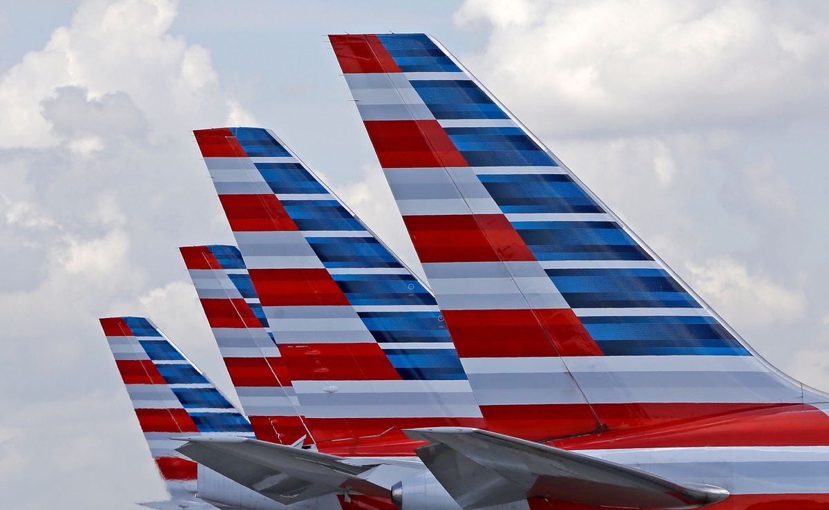 FILE - This July 17, 2015, file photo shows the tails of four American Airlines passenger planes parked at Miami International Airport, in Miami.  (AP Photo/Alan Diaz, File) (AP)