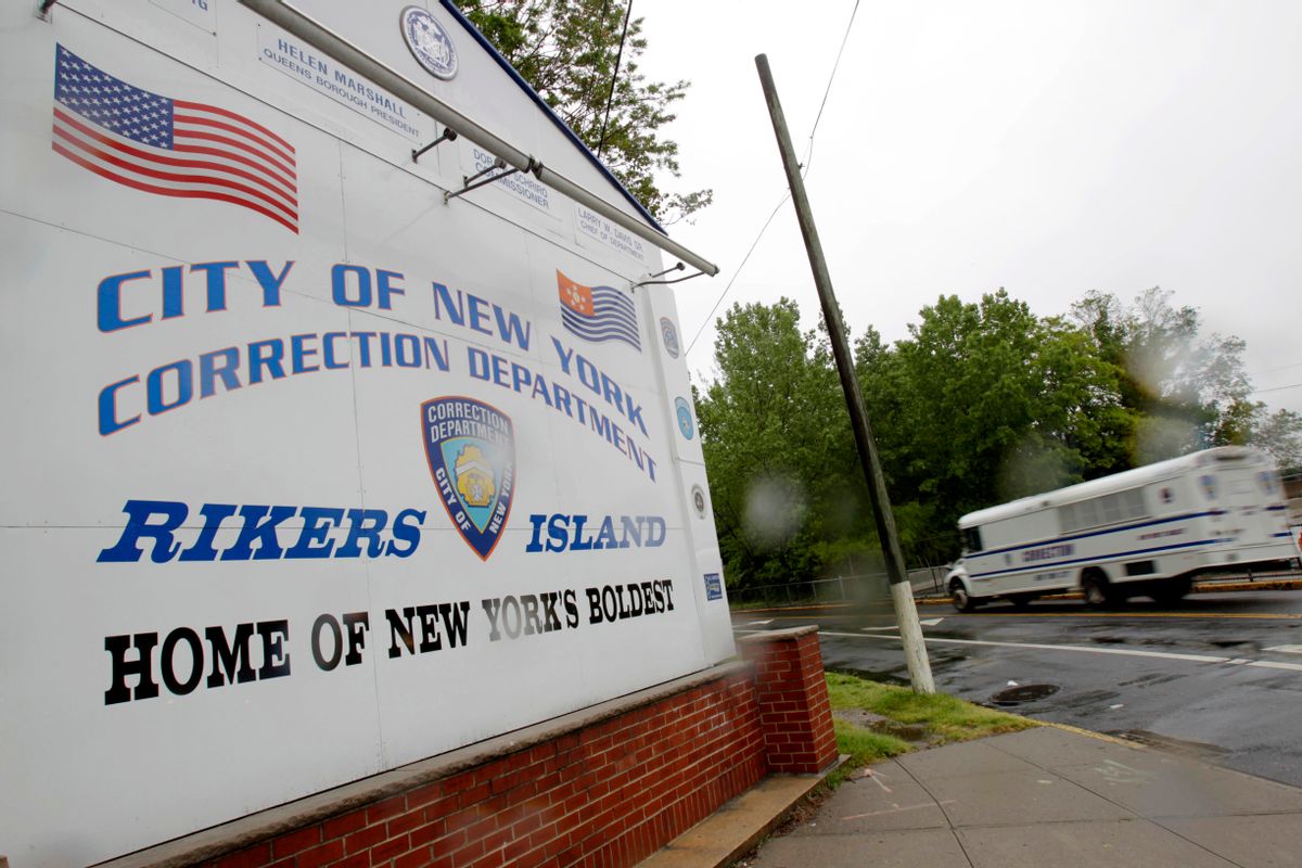 In this May 17, 2011, file photo, a New York City Department of Corrections bus passes the sign near the gate at the Rikers Island jail complex in New York. (AP Photo/Seth Wenig, File)