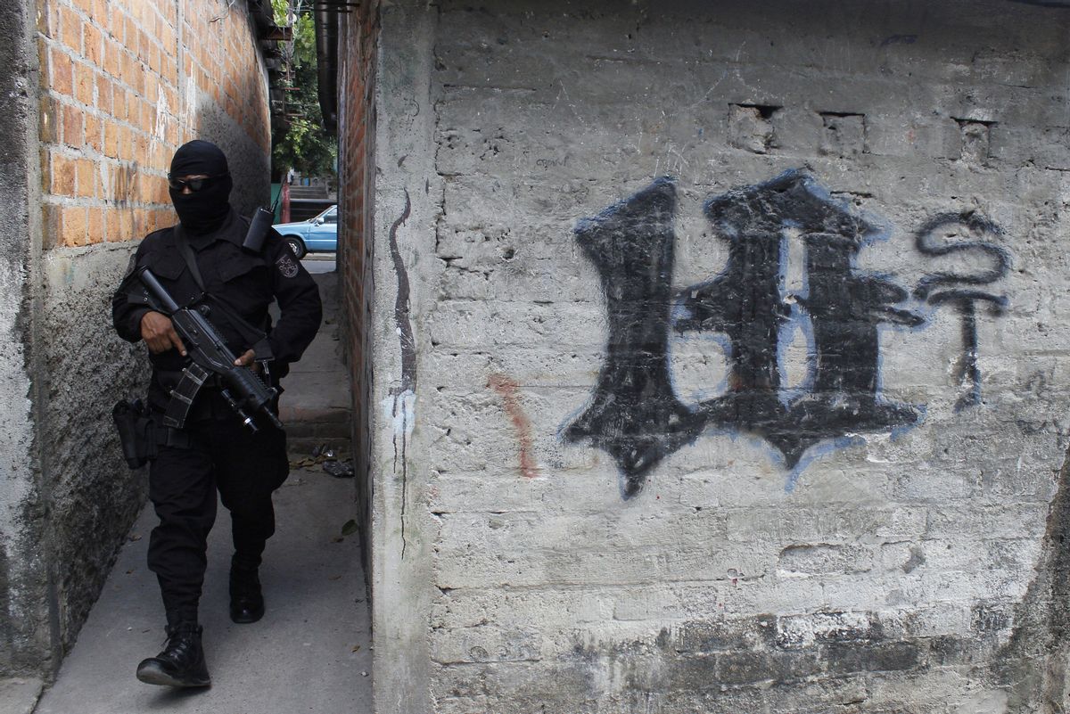 FILE - This April 5, 2016 file photo shows a masked, armed police officer patrolling a gang controlled neighborhood in San Salvador, El Salvador. Government statistics show a sharp drop in homicides so far in 2017 after the gang-plagued country posted some of the world's highest murder rates in recent years, according to National police Commissioner Howard Cotto on March 1, 2017.  (AP Photo/Alex Peña, File) (AP)