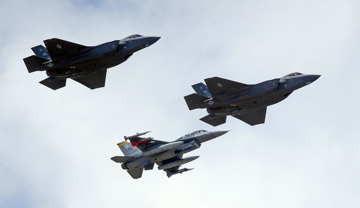 FILE - This Sept. 2, 2015 file photo shows an F-16, below, escorting two F-35 jets, above, after arriving the latter arrived at Hill Air Force Base in Utah. The U.S. and its Asia-Pacific allies are rolling out their new stealth fighter jet, a cutting-edge plane that costs about $100 million each. (AP Photo/Rick Bowmer, File) (AP)
