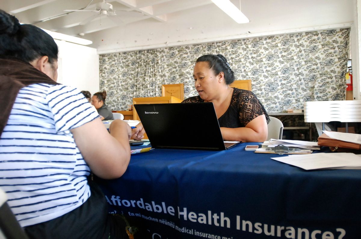 FILE - In this Jan. 30, 2017 file photo, Cinder Sonis, right, an advocate with Legal Aid Society of Hawaii, helps a customer enroll in an Affordable Care Act health insurance plan in Honolulu. Allowing insurers to market health care policies across state lines is one of President Donald Trump's main ideas for bringing down costs. While supporters of the idea cast it as a way to make insurance policies more competitive, critics say it's unlikely to result in more affordable plans and could undermine stronger consumer protections in states such as California and Hawaii. (AP Photo/Cathy Bussewitz, File) (AP)