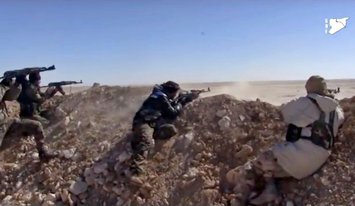 FILE - This frame grab from a  March 6, 2017 video provided by the Syria Democratic Forces (SDF), shows fighters from the SDF opening fire on a position of the Islamic State group in the countryside east of Raqqa, Syria. As the American –backed SDF fighters bear down on Raqqa, the militants have trapped the city’s estimated 300,000 residents to use as human shields, ringing the city with land mines to prevent escape. (Syria Democratic Forces, via AP, File) (AP)