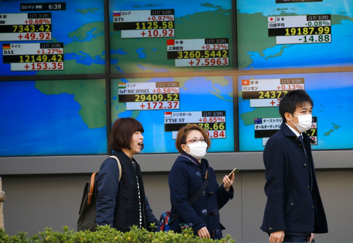 People walk past an electronic stock indicator of a securities firm in Tokyo, Wednesday, March 29, 2017. Asian stocks were listless Wednesday as investors weighed strong U.S. economic reports against uncertainty as Britain readies a formal request to leave the European Union. (AP Photo/Shizuo Kambayashi) (AP)
