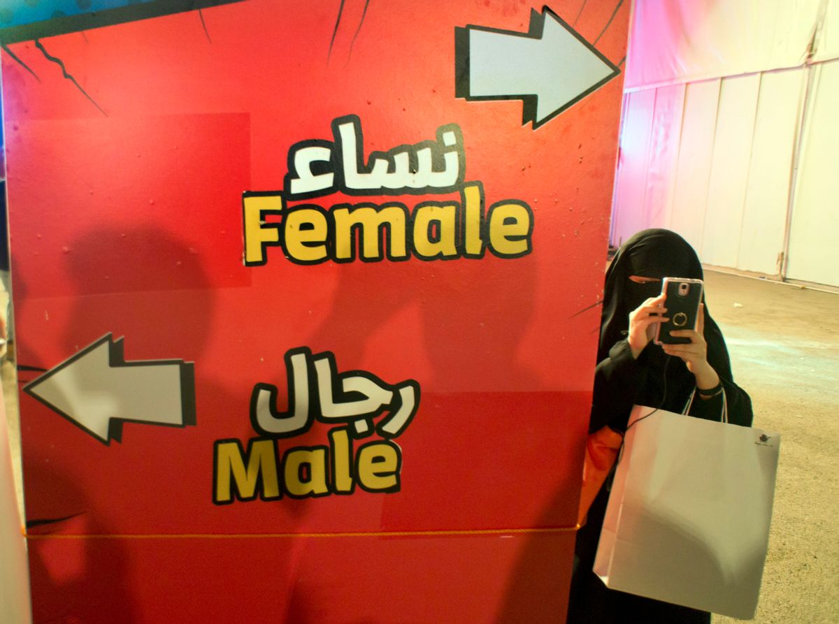 FILE - In this Friday, Feb. 17, 2017, file photo, a visitor takes pictures at the entrance of the female section, during the Saudi Comic Con (SCC) which is the first event of its kind to be held in Jiddah, Saudi Arabia. The kingdom, which bans movie theaters and other entertainment venues, is challenging its ultraconservative image and loosening the reins on fun by opening its doors to live shows, including some American ones. (AP Photo, File) (AP)