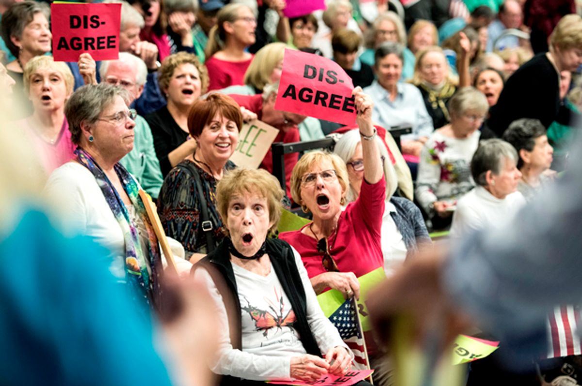 People in the crowd respond to a woman supporting President Donald Trump during a town hall meeting with Rep. Mark Sanford (R-SC)    (Getty/Sean Rayford)