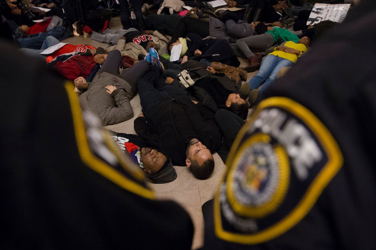 Protesters participate in a "die-in" at Grand Central Station for death of Eric Garner, Saturday, Dec. 6, 2014. (AP Photo/John Minchillo)