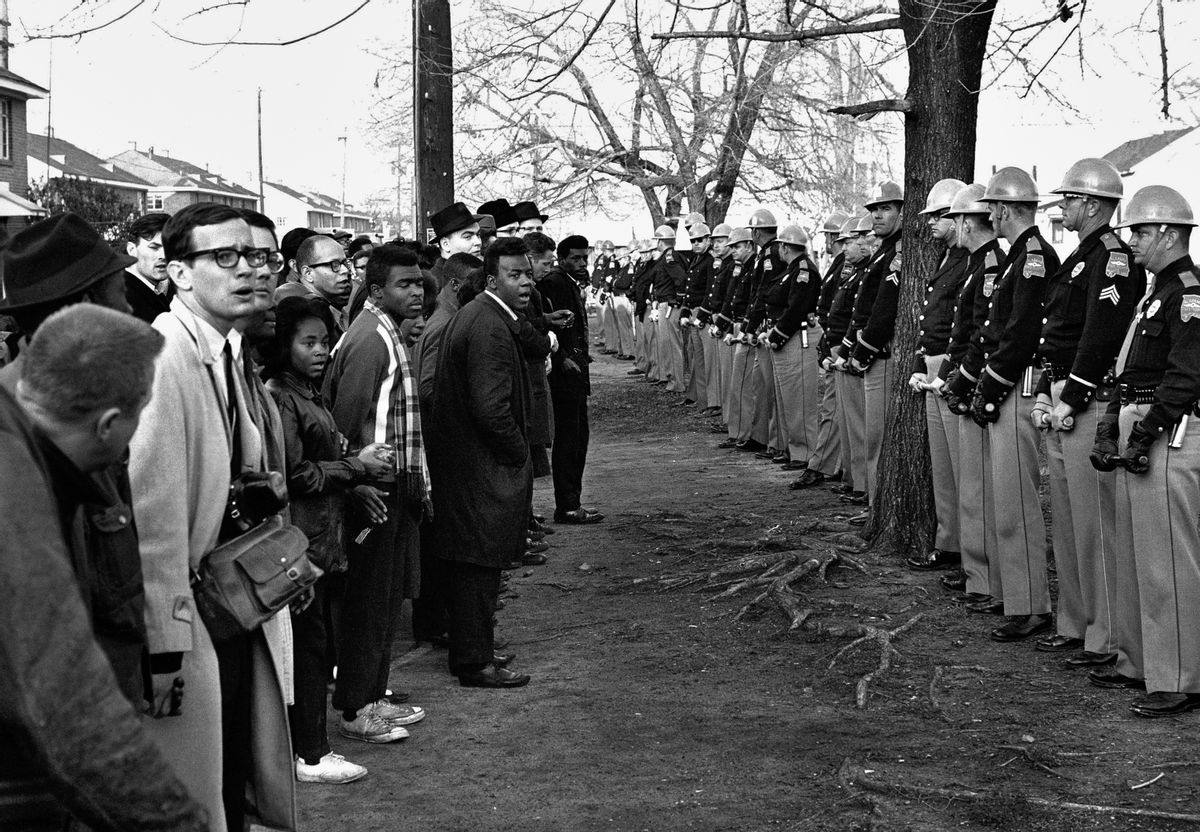 In this March 13, 1965 file photo, a line of police officers hold back demonstrators who attempted to march to the courthouse in Selma, Ala. (AP Photo/File)
