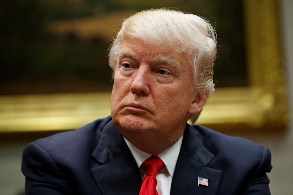 In this March 31, 2017, photo, President Donald Trump listens during a meeting with the National Association of Manufacturers in the Roosevelt Room of the White House in Washington. Slim majorities of Americans favor independent investigations into Trump’s relationship with the Russian government and possible attempts by Russia to influence last year’s election according to a new poll by The Associated Press-NORC Center for Public Affairs Research. (AP Photo/Evan Vucci) (AP)