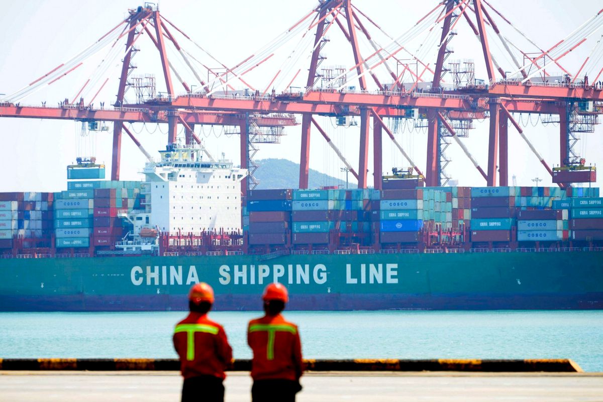 Workers stand watch as containers are loaded into a cargo ship at Qingdao Port in Qingdao in east China's Shandong province, Thursday, April 13, 2017. China's export growth accelerated in March in a positive sign for global demand, though import growth cooled. (Chinatopix via AP) (Chinatopix via AP)