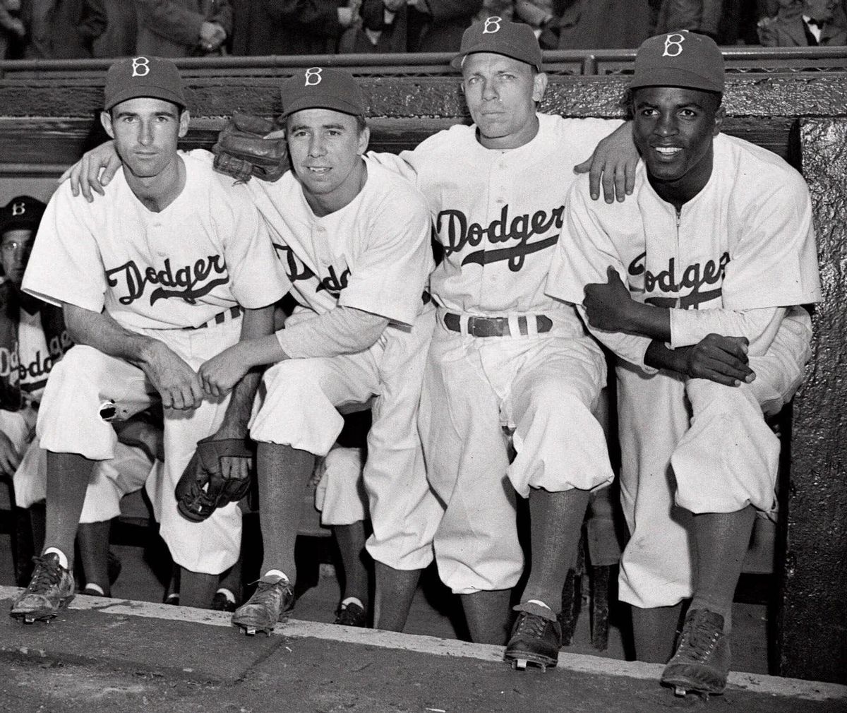 FILE - In this April 15, 1947, file photo, from left, Brooklyn Dodgers baseball players John Jorgensen, Pee Wee Reese, Ed Stanky and Jackie Robinson pose at Ebbets Field in New York. The first statue in Dodger Stadium history belongs to Jackie Robinson. The team will unveil his likeness during Jackie Robinson Day festivities on Saturday, April 15, 2017, with his wife and extended family in attendance on the 70th anniversary of him breaking baseball's color barrier (AP Photo, File) (AP)
