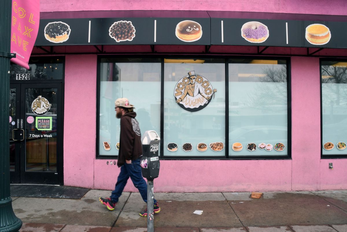 A man walks past the storefront of Voodoo Doughnuts (AP Photo/Thomas Peipert) (AP)