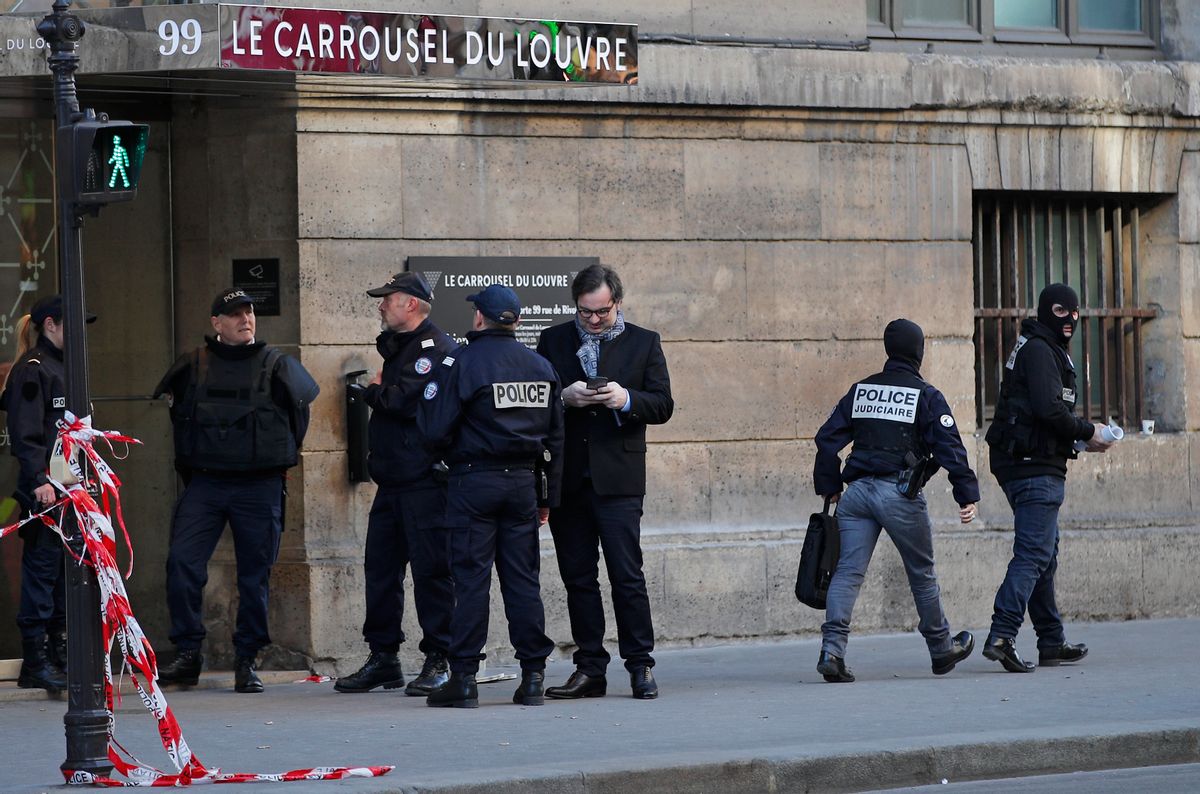FILE - In this Feb. 3, 2017 file photo, police officers cordon off the area outside the Louvre museum as a soldier opened fire after he was attacked in Paris. With the scars and threat of extremist violence looming over France's presidential election, voters will cast ballots under a state of emergency that is becoming a part of the fabric of French life. (AP Photo/Christophe Ena, File) (AP)