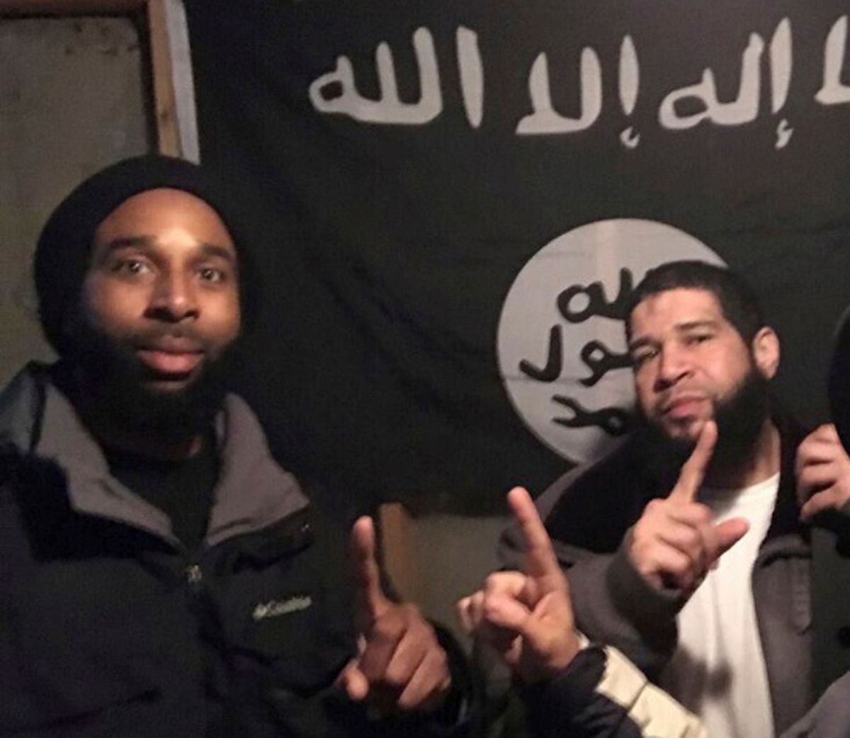 In this undated photo provided by the Federal Bureau of Investigation Joseph D. Jones, left, and Edward Schimenti pose in front of an Islamic State group flag. Jones and Schimenti were arrested by FBI agents on Wednesday, April 12, 2017 on terrorist charges for allegedly conspiring to support the Islamic State militant group. (FBI via AP) (AP)