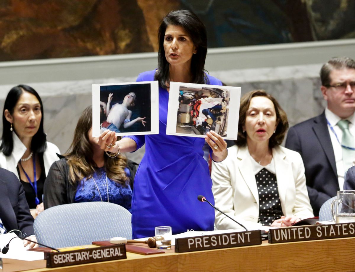 Nikki Haley, United States' Ambassador United Nations, shows pictures of Syrian victims of chemical attacks as she addresses a meeting of the Security Council on Syria at U.N. headquarters, Wednesday, April 5, 2017. (AP Photo/Bebeto Matthews) (AP)