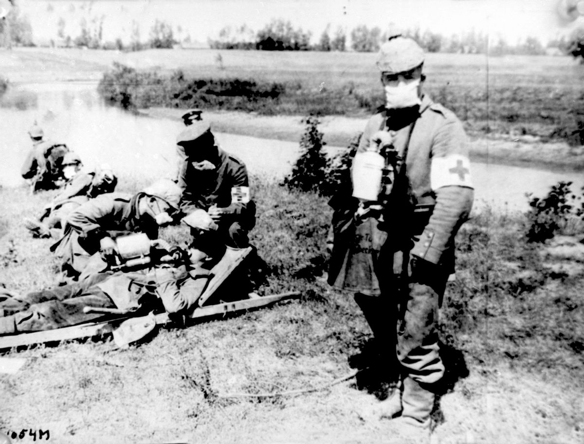 FILE - In this undated file photo, German Red Cross workers carry bottles of liquid to help revive those who have succumbed to a gas attack during World War I. Poison gas was introduced into modern warfare during World War I and remains a threat for both civilian and military populations to this day. Thursday, April 6, 2017, marks the 100th anniversary of the U.S. entry into World War I, and some of the innovations that were developed or came into wide use during the conflict are still with us today, from machine guns and tanks to trench coats and wristwatches. (AP Photo, File) (AP)