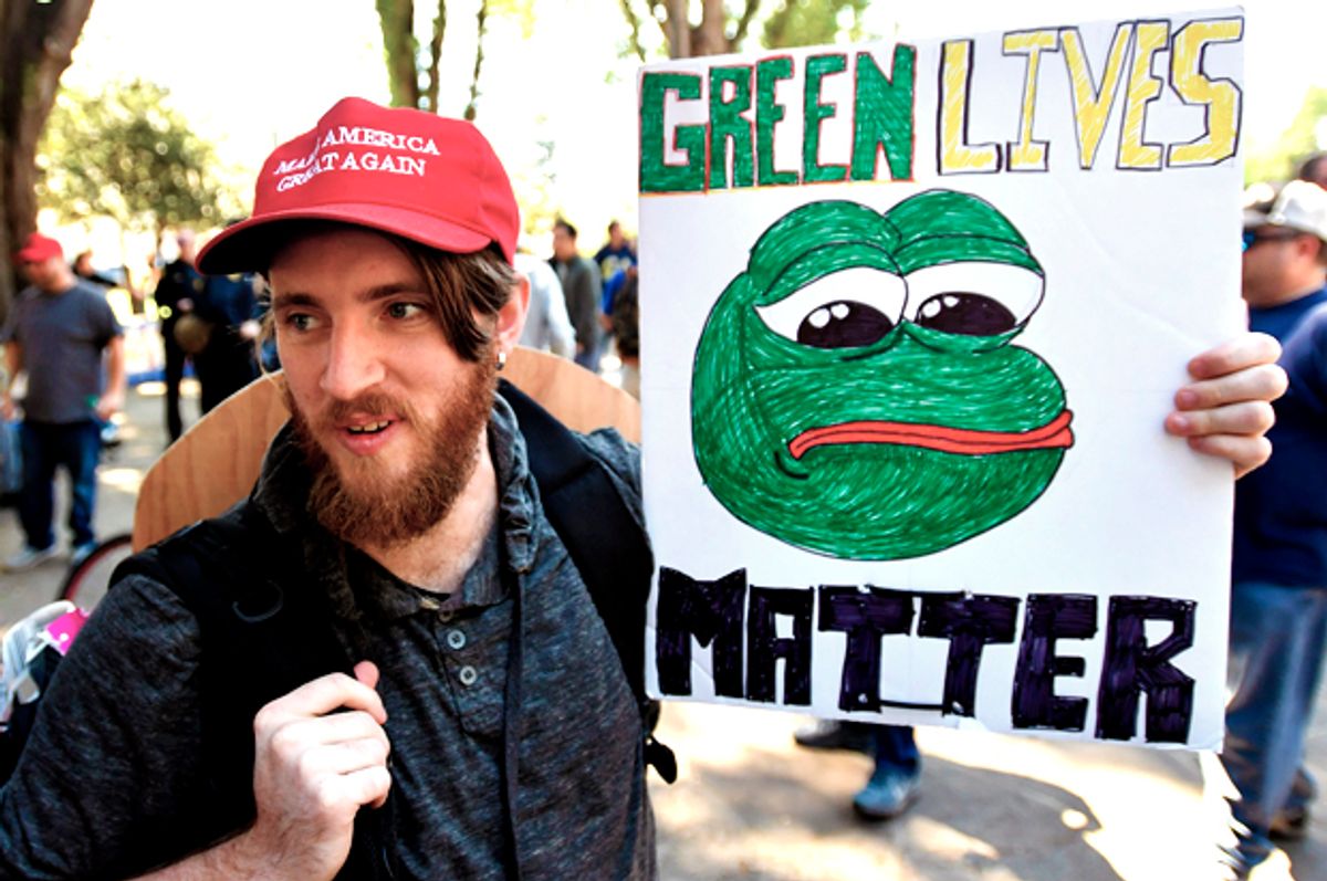 A Trump supporter holds a sign bearing the image of Pepe the Frog.  (Getty/Josh Edelson)