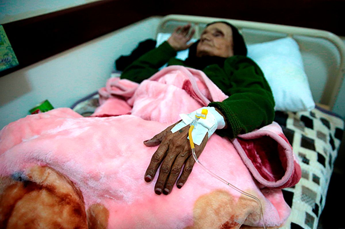 An elderly woman is treated for suspected cholera (AP/Hani Mohammed)