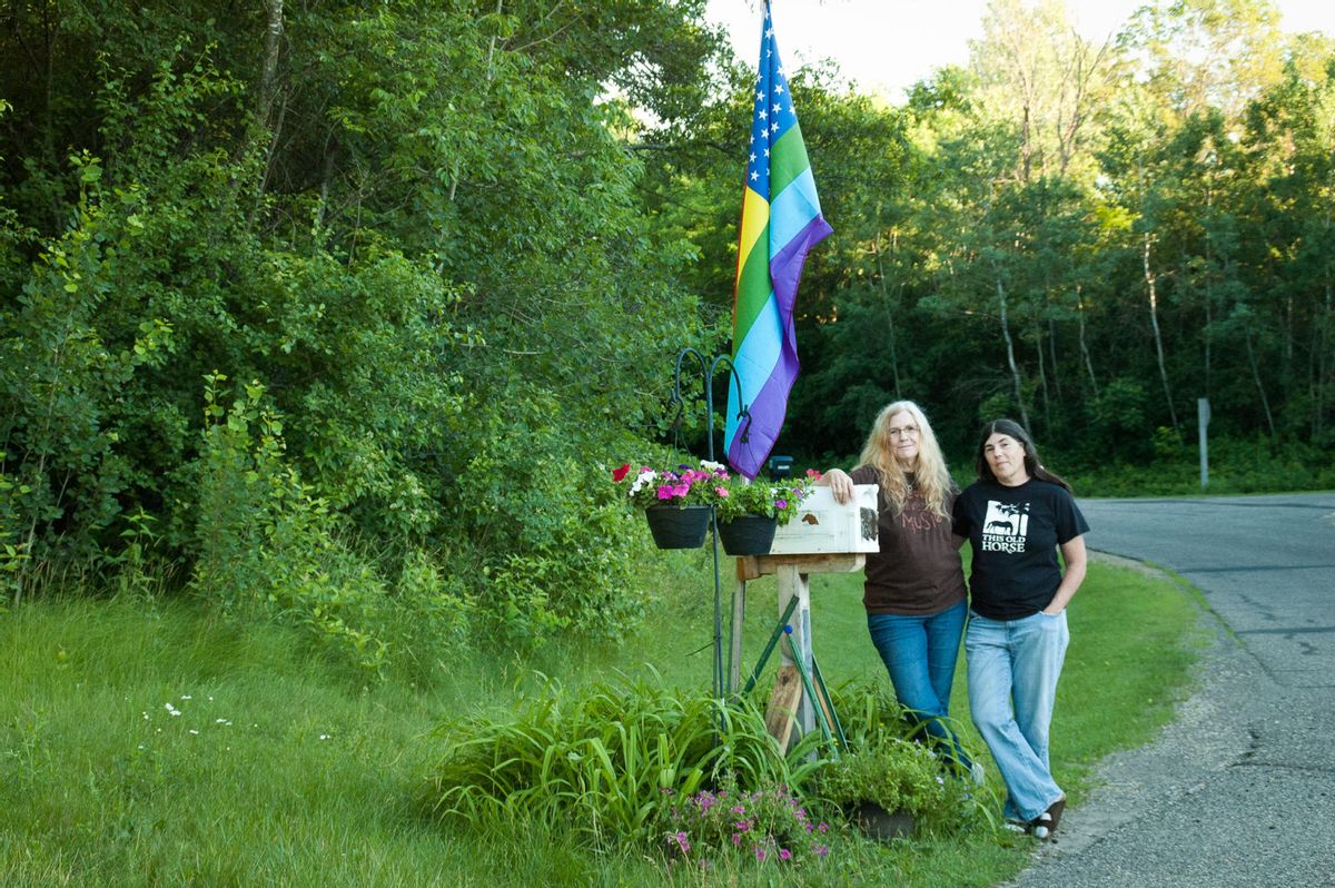The author, left, and Wendy, with their flag at the end of their drive. (Chris LeRoux/Narratively)
