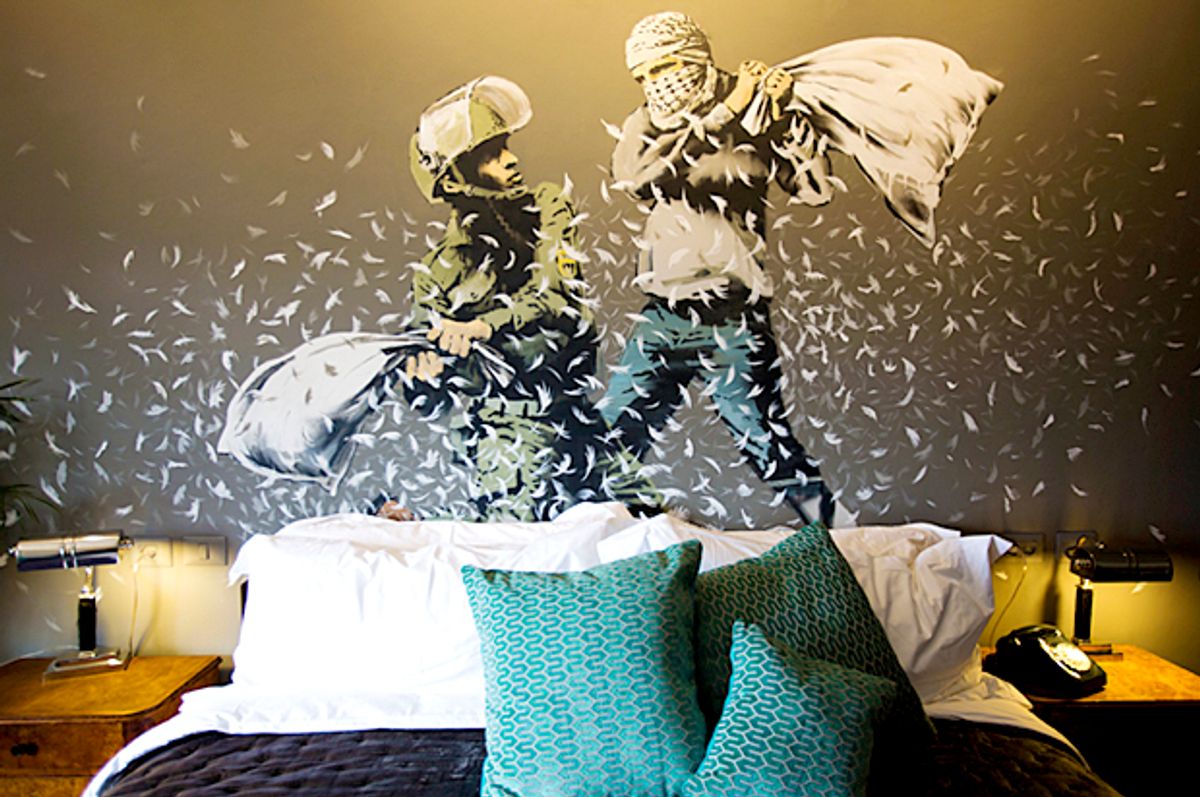 A Banksy wall painting showing Israeli border policeman and Palestinian in a pillow fight. (AP/Dusan Vranic)