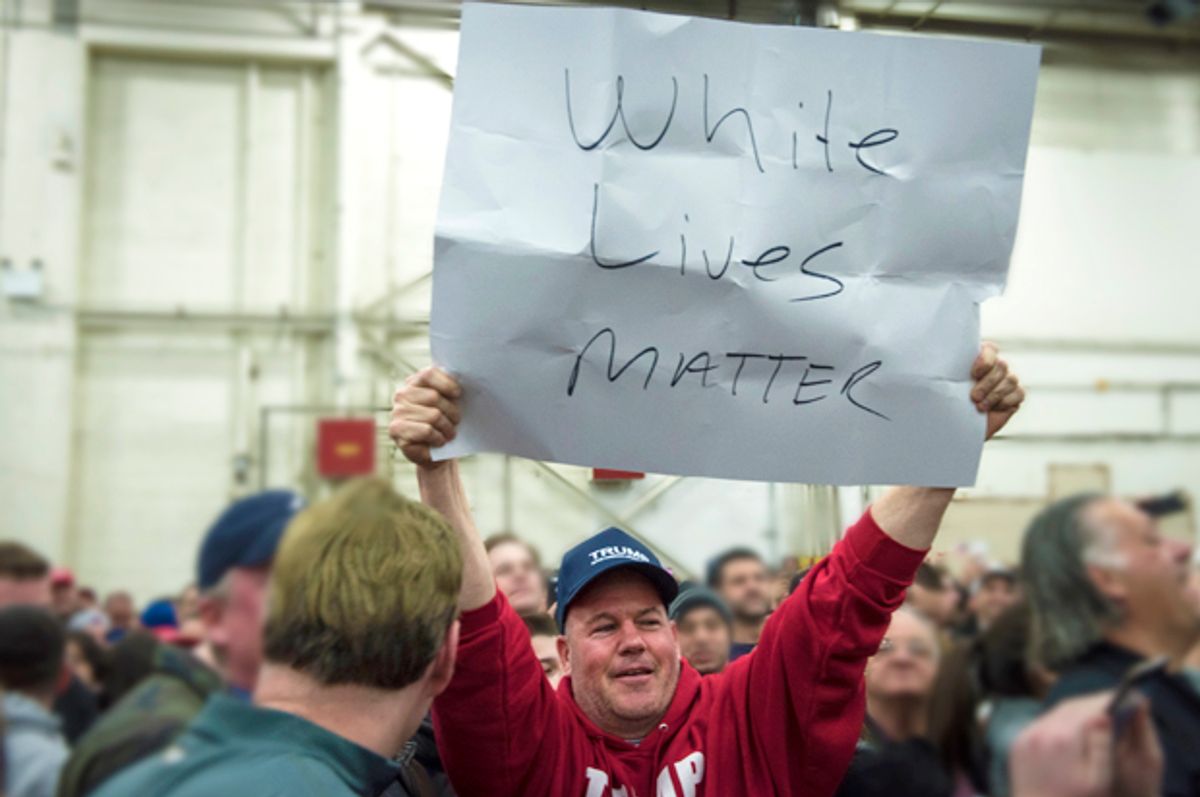 A Trump supporter holds up a "White Lives Matter" sign (Getty/Andrew Renneisen)