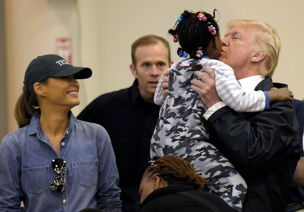President Donald Trump and Melania Trump meet people impacted by Hurricane Harvey during a visit to the NRG Center in Houston, Saturday, Sept. 2, 2017.  He lifted this girl into his arms to give her a kiss.  It was his second trip to Texas in a week, and this time his first order of business was to meet with those affected by the record-setting rainfall and flooding. He’s also set to survey some of the damage and head to Lake Charles, Louisiana, another hard-hit area. (AP Photo/Susan Walsh) (AP)