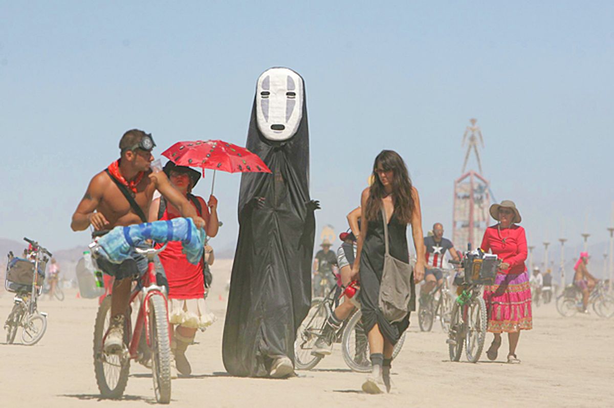 Burning Man participants walk on the playa at the Black Rock Desert (AP/Brad Horn)