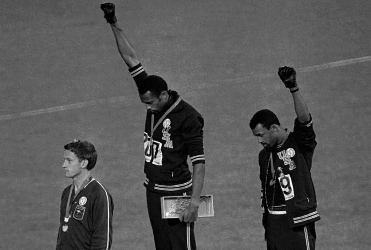 Tommie Smith and John Carlos extend their fists during the playing of the "Star-Spangled Banner" after  the 200-meter run at the Summer Olympic Games in Mexico City, Oct. 16, 1968. (AP)